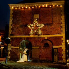 The Kings Chapel newlyweds captured in Old Amersham High Street at dusk on their Christmassy wedding day 