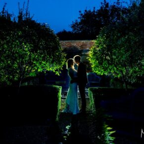 This backlit silhouette shot was captured in one of The Manor House Hotel's hidden gardens. The lush green foliage and backlighting combine perfectly for this dramatic capture. The simplicity and limited colour palette is what really makes this image work so perfectly. I carry floodlighting to every wedding for these grand finale style shots, and they are as popular as ever come summer or winter. The newlyweds captured in silhouette at dusk during their Manor House Hotel wedding in Moreton-in-Marsh