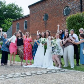 The wedding couple and their friends strike a pose outside The Kings Chapel's in Old Amersham 