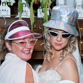 The bride and a girlfriend in the wedding photo-booth at The Kings Chapel in Old Amersham 