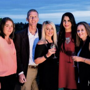 Buckinghamshire events photography of a relaxed sunset pose of five delegates on the roof terrace at Cliveden House 