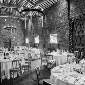 Dramatic black and white photography of  Buckinghamshire barn interior pre wedding breakfast
