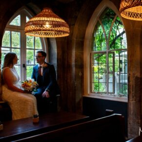 Dramatic silhouette photography of the newlyweds in a feature window at their Buckinghamsihre pub wedding 