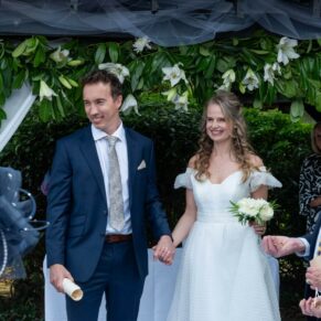 Photography of the smiling newlyweds exiting their outdoor wedding ceremony at Fredrick's Hotel in Berkshire