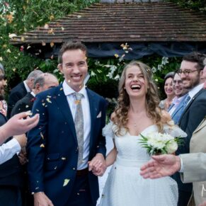 Photography of the bride and groom exiting their wedding ceremony in the gardens at Fredrick's Hotel in Berkshire