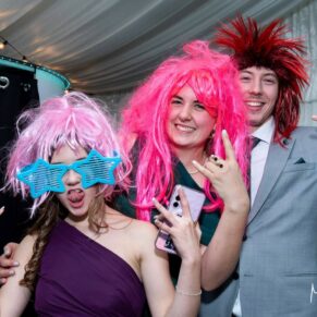 Winters Tale Country Barn wedding photography of some of the evening guests enjoying the funky photo-booth wigs and props
