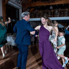 Winters Tale Country Barn wedding photography of the groom enjoying a high octane dance with the young bridesmaid